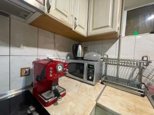 a red mixer sitting on a counter in a kitchen at Guest House Robin Hud in Cherni Osŭm