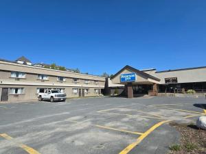 a car parked in a parking lot in front of a hotel at Rodeway Inn in Sudbury
