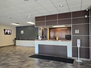 a large kitchen with a counter in a room at Rodeway Inn in Sudbury