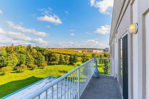 a balcony with a view of a field and trees at Comfort Inn & Suites in Kincardine