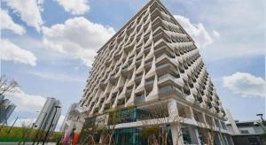 a tall building with a lot of windows at Gloucester Hotel Kintex in Isan