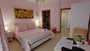 a bedroom with a large white bed and a table at Boat dreams , garden relax in Matino