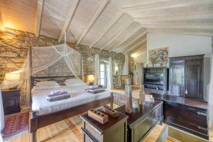 a bedroom with a bed and a stone wall at Beautiful stone holiday house MENTA I in Bajčići