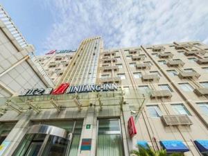 a tall building with a sign on top of it at Jinjiang Inn Shanghai Jinshang City Beach in Jinshan