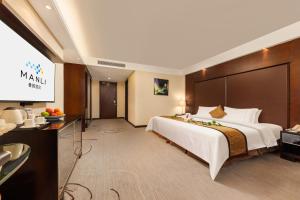 Ένα ή περισσότερα κρεβάτια σε δωμάτιο στο 南山海岸城曼骊酒店 +31 φωτογραφίες