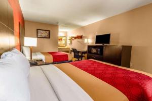 a hotel room with two beds and a flat screen tv at Econo Lodge Meridian South in Meridian