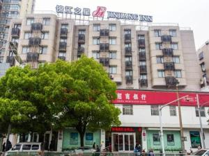 a large building with a sign on top of it at Jinjiang Inn Nanjing Maigao Bridge in Nanjing