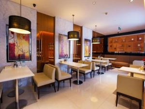 a dining room with tables and chairs in a restaurant at Jinjiang Inn Nanjing Maigao Bridge in Nanjing