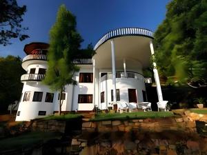 a white building with a tower on top of it at The Hideaway Hotel in Egodagama
