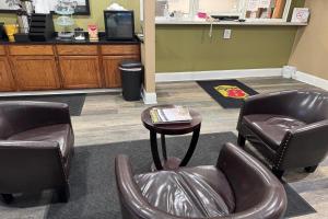 a waiting room with two chairs and a table at Super 8 by Wyndham Mendota I-39 in Mendota