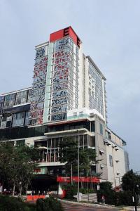 a tall building with red and white signs on it at NuEmpire Subang Suite - Empire Hotel in Subang Jaya