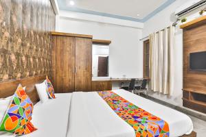 a hotel room with a bed and a tv at FabHotel Anant Inn in Lucknow