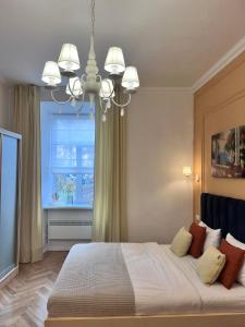a bedroom with a large bed with a window at Siesta apartment on Stefanyka in Lviv