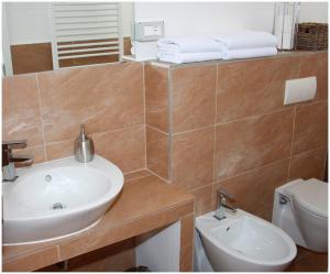 a bathroom with a sink and a toilet at Apartments Ercegovic in Primošten +23 photos