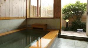 a pool of water in a room next to a window at Pension Twilight in Nasu-yumoto