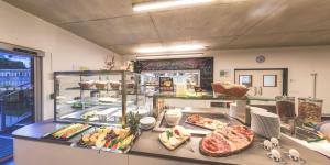 a buffet line with many different types of food at DJH Jugendherberge Chemnitz "eins" in Chemnitz +12 photos