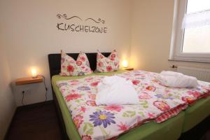 a bedroom with a bed with two pillows on it at Ober Langengarten in Pittenbach