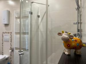 a toy cow sitting on a counter in a bathroom at Ober Langengarten in Pittenbach +33 photos