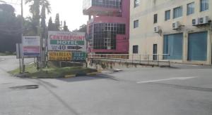 a sign in a parking lot next to a building at Hotel Centrepoint (Self Check In After 5PM) in Kuala Lipis