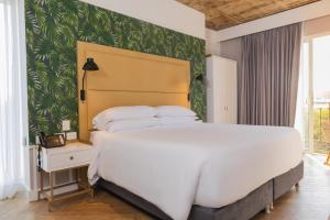 Ένα ή περισσότερα κρεβάτια σε δωμάτιο στο Faranda Collection Barranquilla, a member of Radisson Individuals