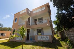 a house in the middle of a yard at Jamii Villas Diani in Kwale
