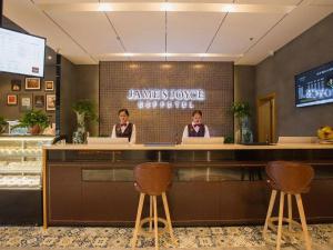 two women sitting at a counter in a restaurant at James Joyce Coffetel· Hefei Anhui Agricultural University in Hefei