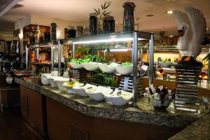 a buffet line with white bowls and plants on a counter at Byotell Istanbul in Istanbul
