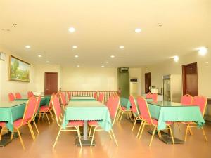 a dining room with tables and chairs in a room at GreenTree Inn Shanghai Waigaoqiao Free Trade Zone Express Hotel in Shanghai