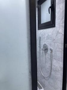 a shower in a bathroom with a glass door at Studio Chic in Mahdia