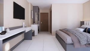 a bedroom with a bed and a tv on the wall at Prajan Residence in Buriram