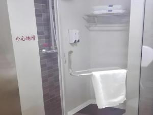 a bathroom with a shower with a toilet and a sink at 7 Days Inn Dongsheng Railway Station in Zhaoyoufang