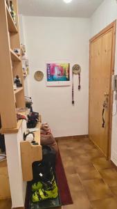 a room with a bunch of shoes on a wall at Facing the Sestriere Ski Slopes in Borgata Sestriere
