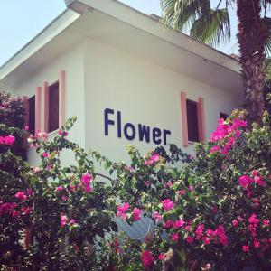 a house with a flower sign on the side of it at Flower Villa Apart in Kemer