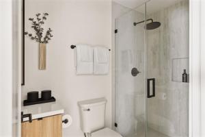 a white bathroom with a shower and a toilet at Tide House - Unit D - Modern Oceanview 1BD w Parking in El Segundo +14 photos