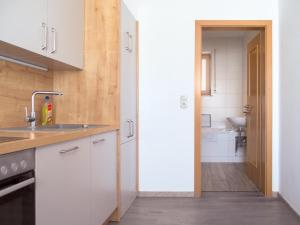 a kitchen with white cabinets and a sink at Landgasthof Benjamin in Treffelstein +78 photos