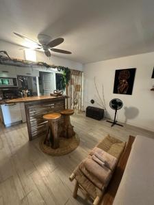 a living room with a table and a kitchen at Studio avec jardin et piscine in Saint-François