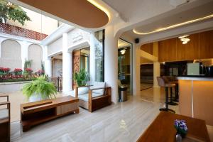 a lobby of a building with a table and chairs at Sira Boutique Chiang Mai in Chiang Mai +110 photos