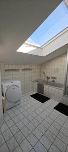 a bathroom with a toilet and a sink and a tub at Villa Levilia in Strullendorf +23 photos