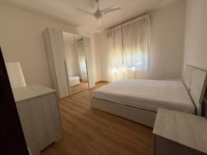 a bedroom with a bed and a large mirror at Casa del Mare in Marotta