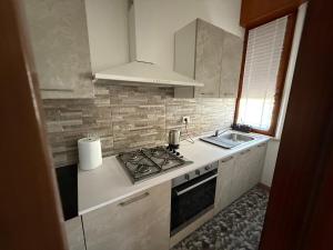 a kitchen with a stove and a sink at Casa del Mare in Marotta