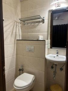 a bathroom with a toilet and a sink at Vista Vagator Junction by Dia Hotels and Homes in Anjuna