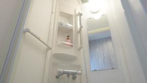 ein Bad mit einer weißen Tür und einem Spiegel in der Unterkunft Grandioso OKINAWA VILLA ONNA 5A - Vacation STAY 97721 in Meta + 35 Fotos