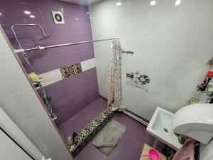 a purple and white bathroom with a shower at KAR & SON guesthouse in Yerevan