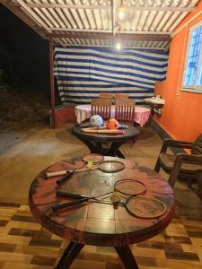 a room with a table with tennis rackets on it at Dark Sky Homestay in Mudigere