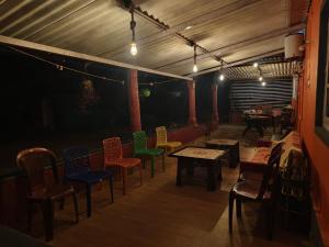a group of chairs and tables in a room at Dark Sky Homestay in Mudigere +29 photos