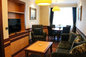 a living room with a couch and a tv and a table at Byotell Istanbul in Istanbul