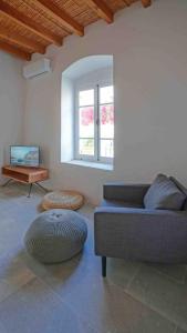 a living room with a couch and a table at stonebuilt HiddenHouse in Paphos