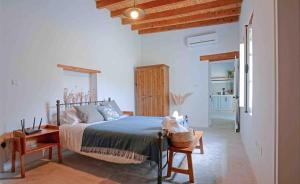 a bedroom with a bed in a room with wooden ceilings at stonebuilt HiddenHouse in Paphos