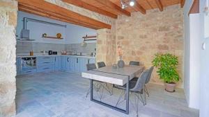 a kitchen with a table and chairs in a room at stonebuilt HiddenHouse in Paphos