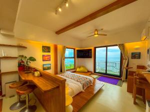 a bedroom with a bed and a desk and a window at Aqua Horizon Art Studio Condo in Dauis +62 photos